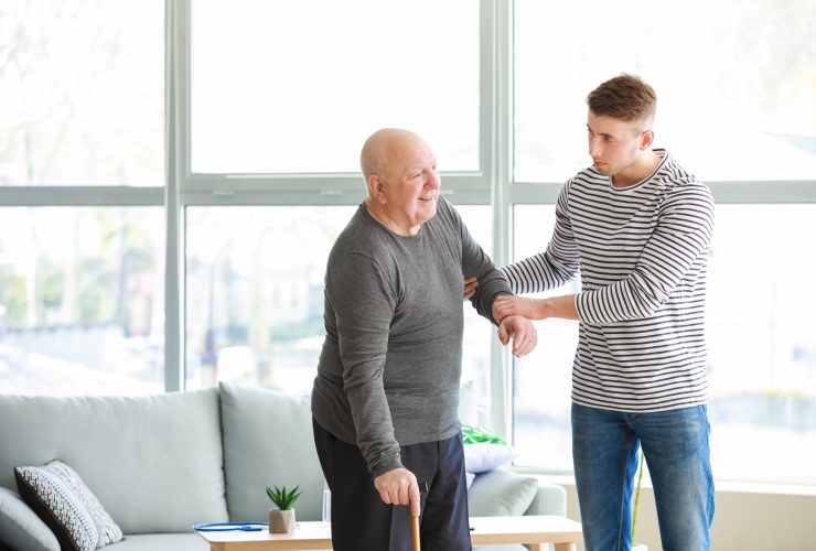 Male caregiver assisting senior with COPD