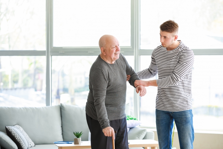 Male caregiver assisting senior with COPD