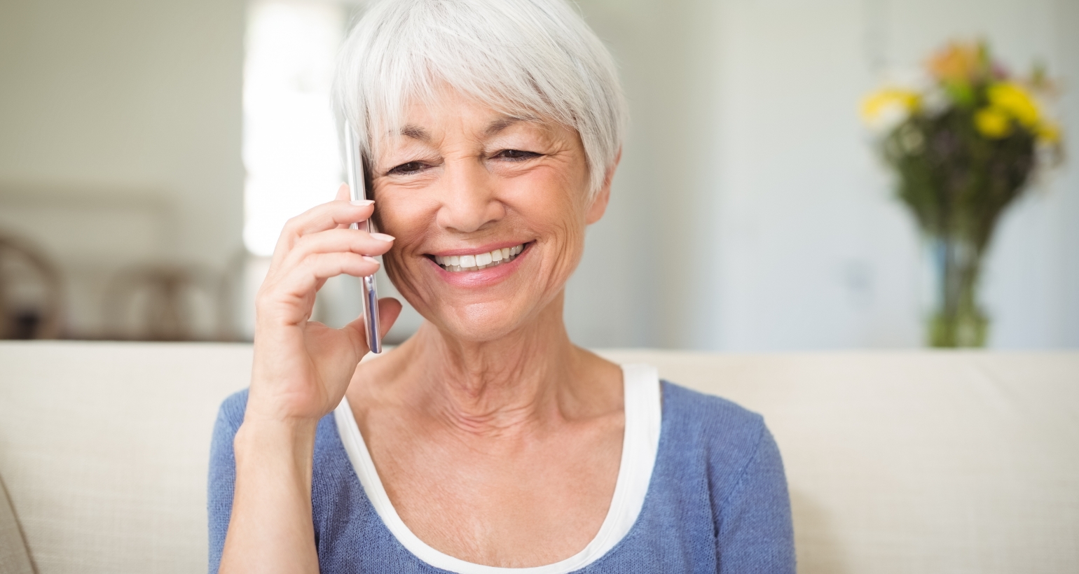 Grandma smiling while talking over the phone